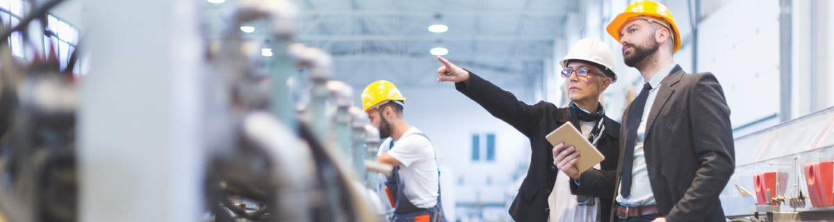 Plant manager and sales person on manufacturing floor